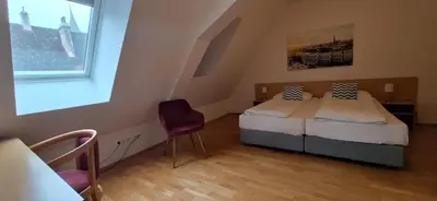 Ein Bett oder Betten in einem Zimmer der Unterkunft Gästehaus Deutscher Orden Wien