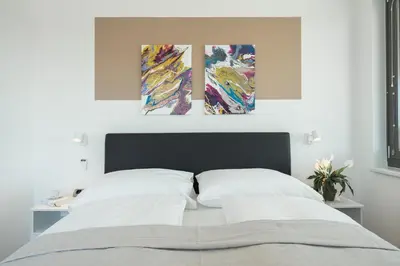 Ein Bett oder Betten in einem Zimmer der Unterkunft FeelGood Apartments LakeLiving inklusive Garagenplatz