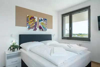 Ein Bett oder Betten in einem Zimmer der Unterkunft FeelGood Apartments LakeLiving inklusive Garagenplatz