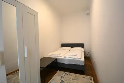 Ein Bett oder Betten in einem Zimmer der Unterkunft UNIVERSUM APARTMENT 4