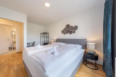 Ein Bett oder Betten in einem Zimmer der Unterkunft Modernes Stadtapartment mit Terrasse