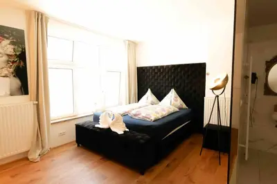 Ein Bett oder Betten in einem Zimmer der Unterkunft XuBa ApartmentRooms I Wien Messe Prater I Küchenzeile