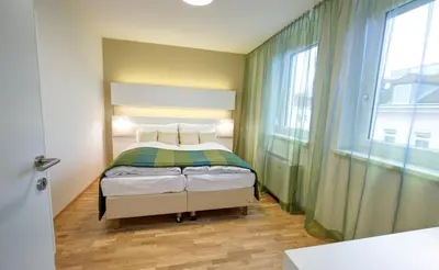 Ein Bett oder Betten in einem Zimmer der Unterkunft Smart Apart Living - Wien HBF